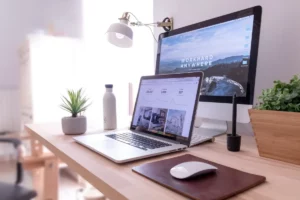 Höhenverstellbarer Schreibtisch in Eichenoptik mit MacBook und Bildschirm